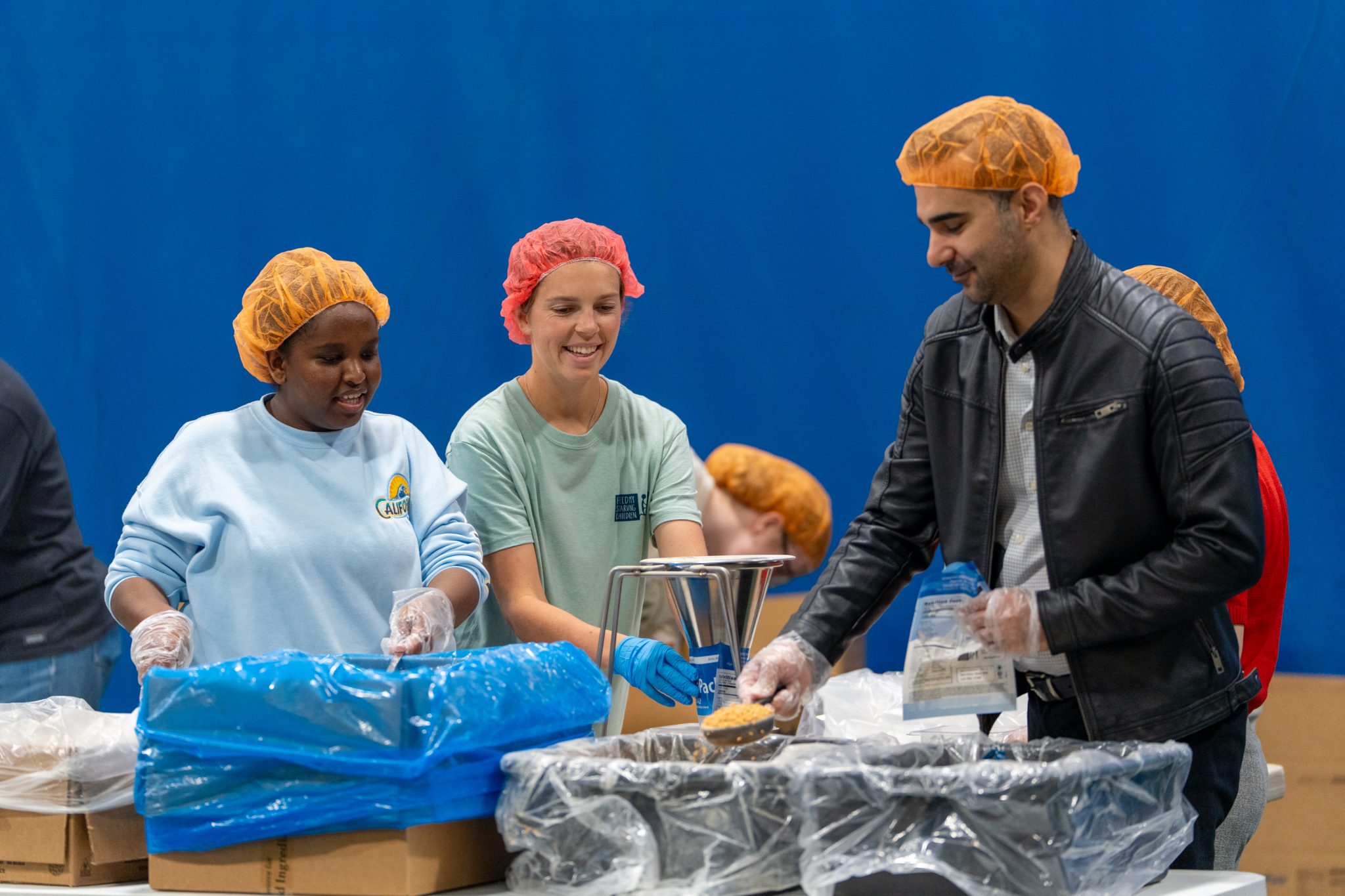 Volunteers pack 113K meals at EMU for hungry children around the world ...